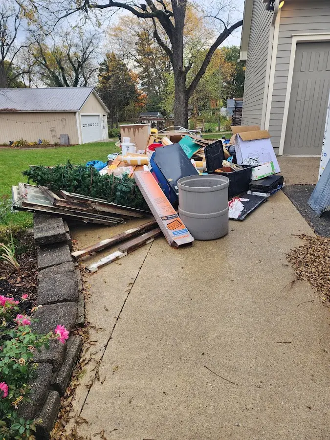 Dumpster being loaded with debris for Roofing Dumpster Rental in Holmen